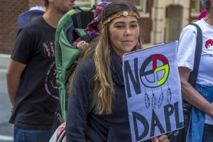 Protestor holding a sign saying, "No DAPL"