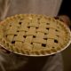Lattice Pie being held by someone in an apron