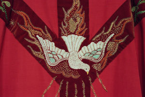a red chasuble with dove detail