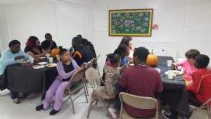Carving pumpkins and enjoying dinner together at The Table