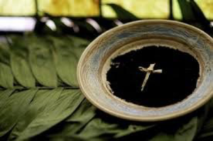 Palm ashes burnt in bowl with dried palm frond cross on top